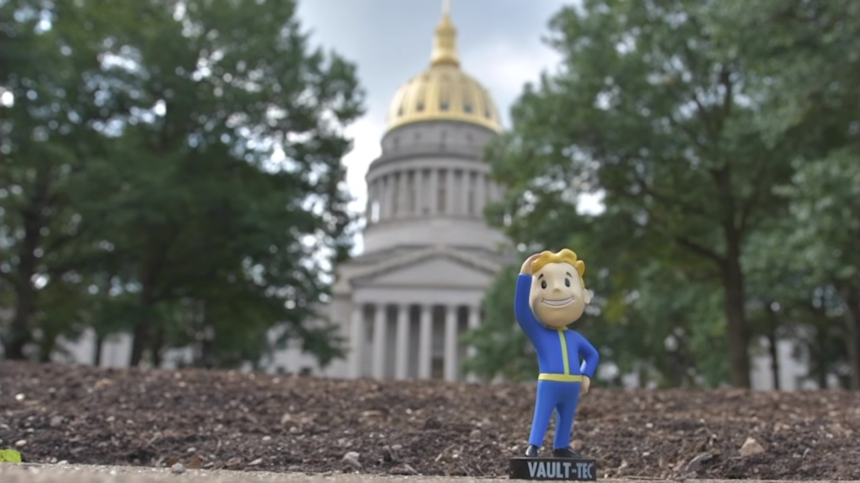 A bobblehead outside on the ground.