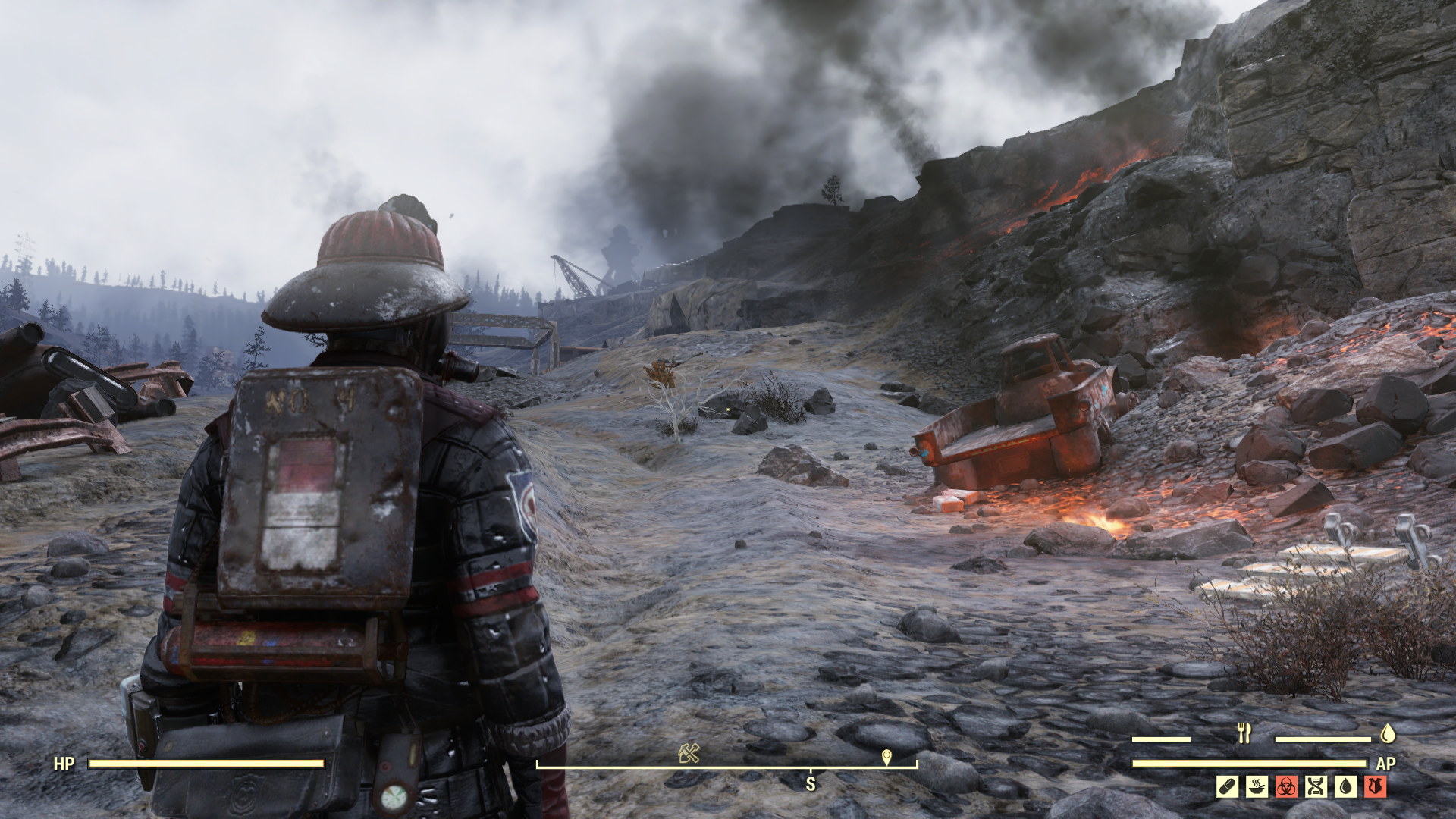 Player dressed in what looks like a fireman's outfit, looking at burning car and a smouldering landscape.