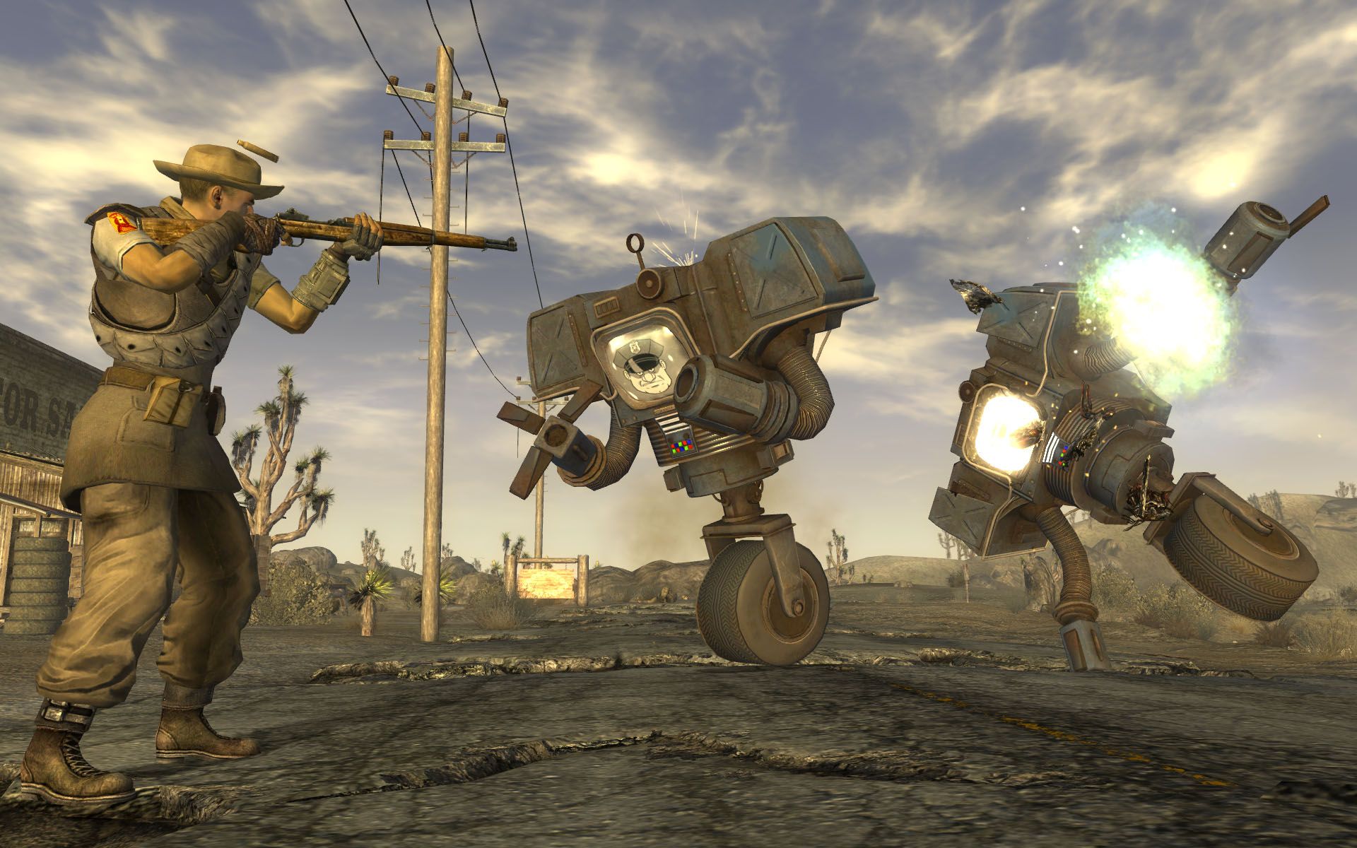 A screenshot of a man shooting two robots in Fallout: New Vegas.