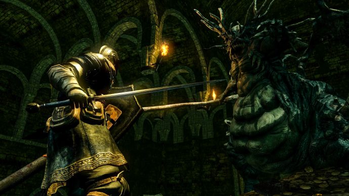 A screenshot of a night facing a huge spider creature in Dark Souls: Remastered.