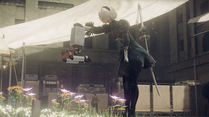 A screenshot of the protagonist 2B petting a small robot in Nier: Automata.