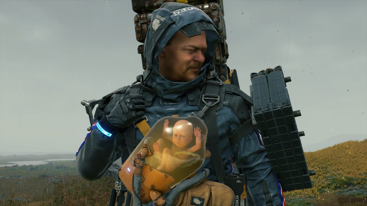 A screenshot of Sam Bridges pulling a strained face with a smiling BB in Death Stranding.