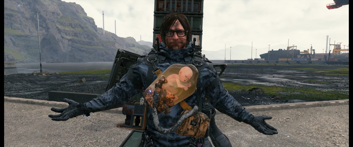 An ultrawide screenshot of Sam Bridges looking smug with his arms out after a tense and dirty boss battle at the port in Death Stranding. 