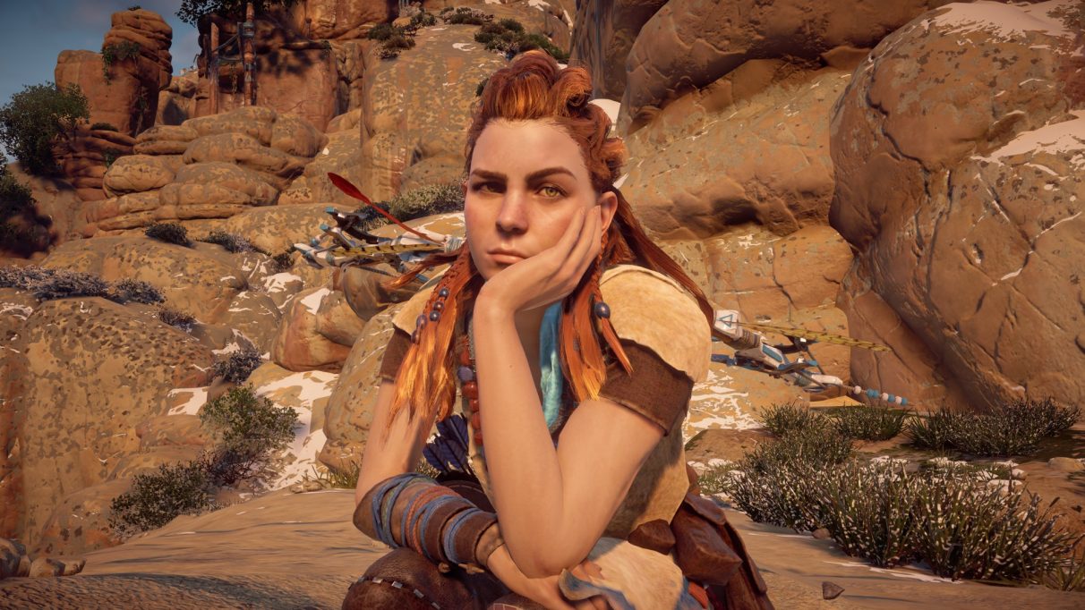 A screenshot of Aloy with her head in her hand from Horizon Zero Dawn.