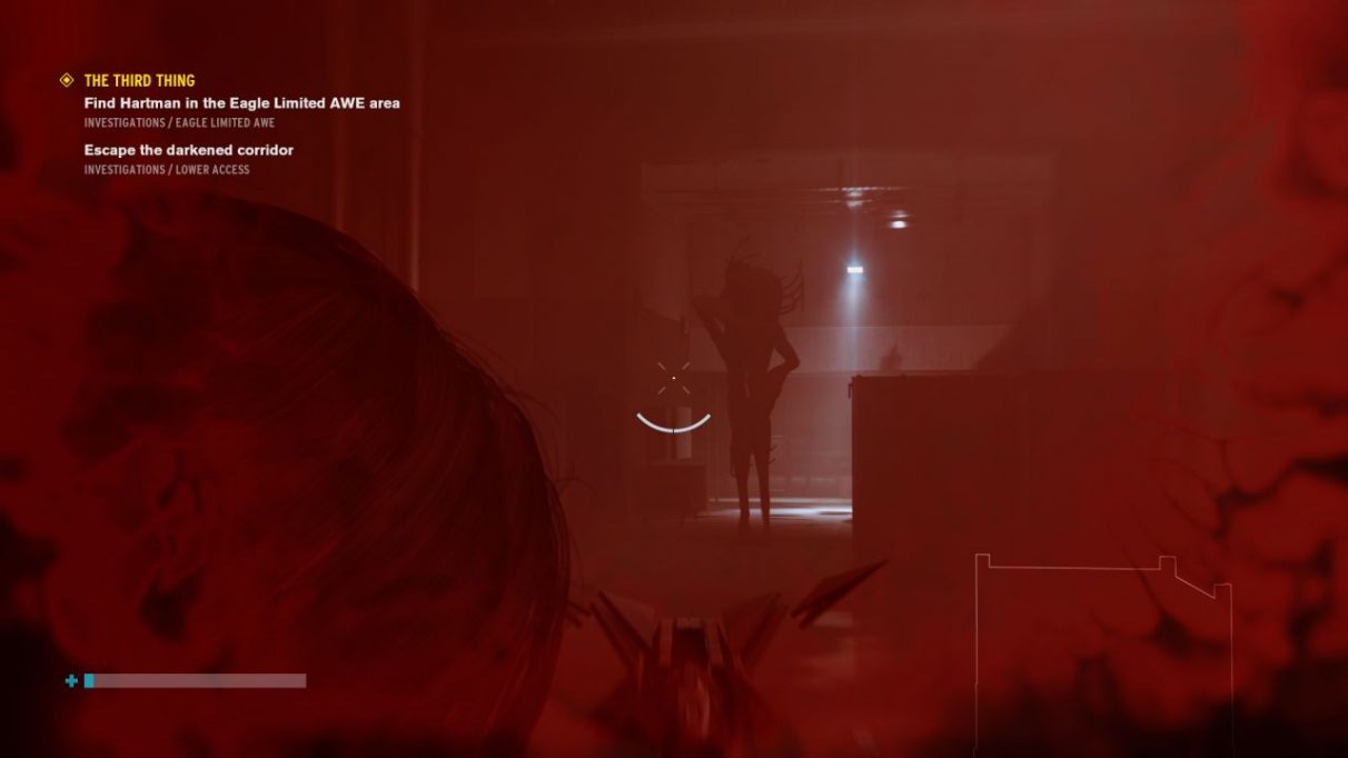 A screenshot from the Control AWE DLC showing main big baddie Hartman, an indistinct shape lurking just in front of a light. His proportions are that of a human, but as if he's been wrung out and stretched, so his arms and legs are unnaturally long. 