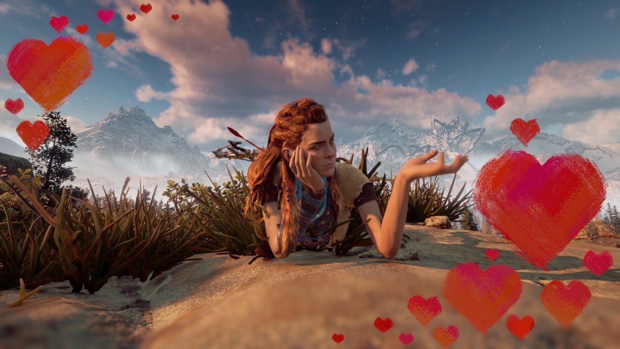 Aloy in a posed photo with the classic gap year instagram illusion that she's "holding" a wrecked machine on a distant mountaintop. There is a border of love hearts.