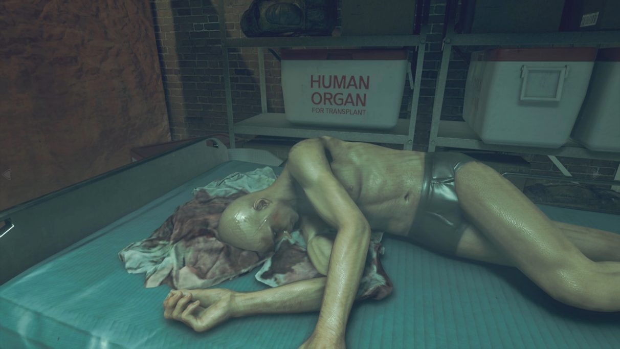 A horrific cadaver; a box behind it is labelled as containing human organs