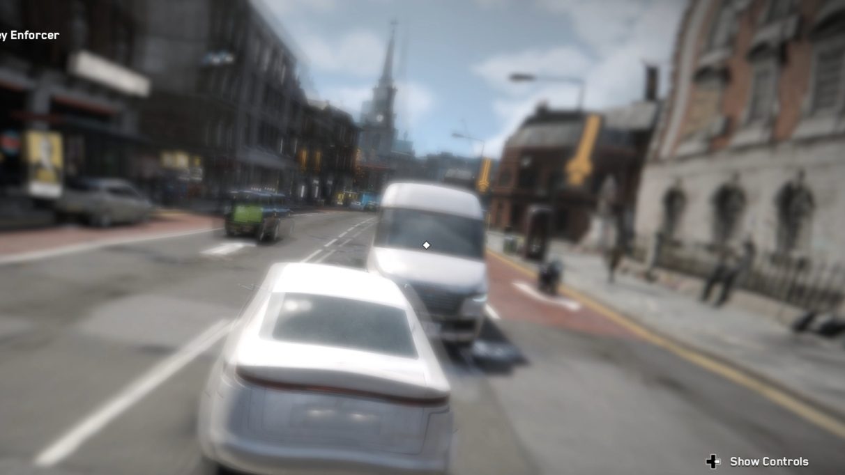 Wobbly, blurry shot of a car driving into oncoming traffic. There might be a Hawksmoor church in the background?