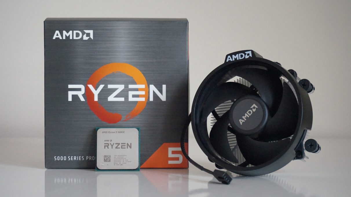 A photo of AMD's Ryzen 5 5600X CPU in front of its retail box and its accompanying Wraith Stealth cooler.