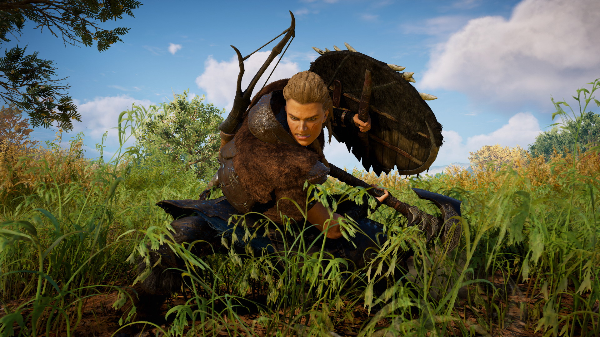 A screenshot of Eivor cutting grass with her axe in Assassin's Creed Valhalla.