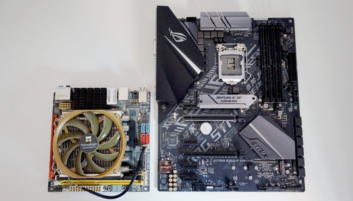 A photo showing a mini-ITX motherboard next to a larger ATX-sized motherboard.