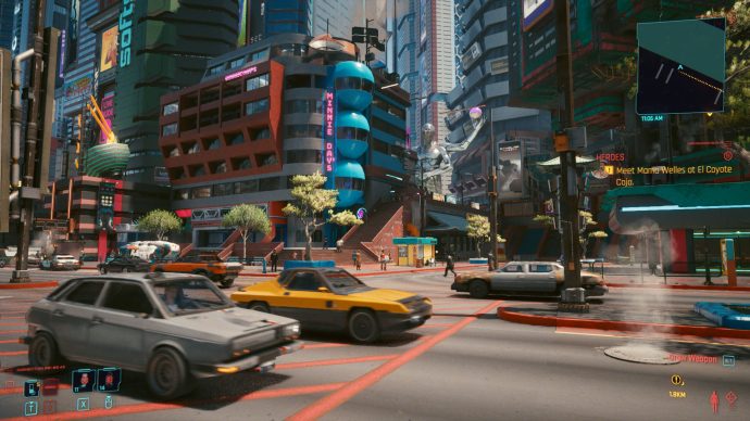 A screenshot of Cyberpunk 2077's Night City, busy with detail. There are cars whizzing by in the foreground, colourful buildings in the distance, and an enormous statue nestled among them. 